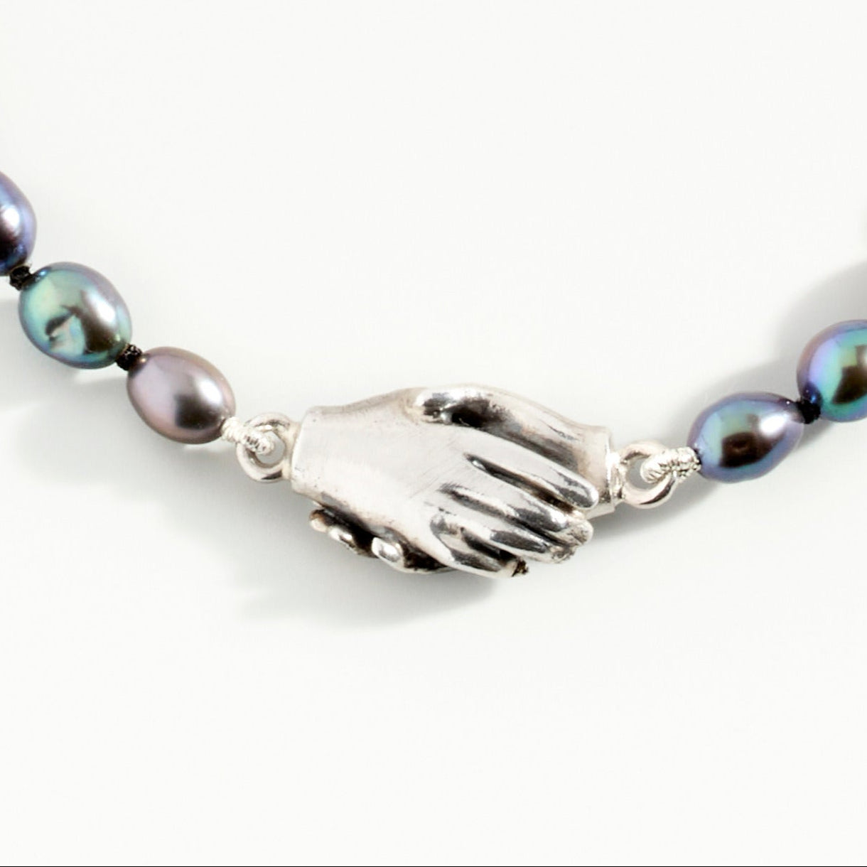 Clasped Hands Peacock Pearl Bracelet by Emma White