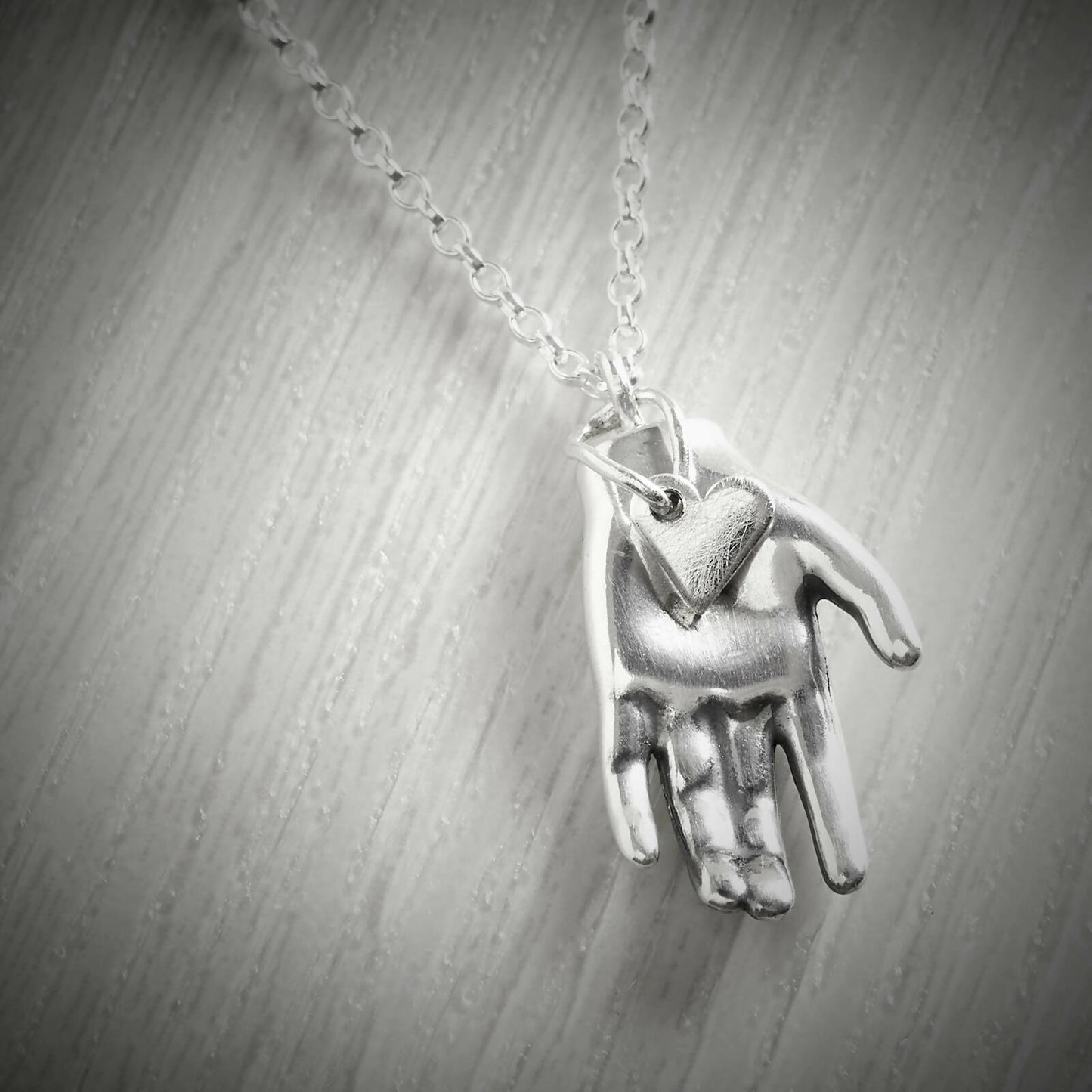 Silver Heart in Hand Necklace by Emma White