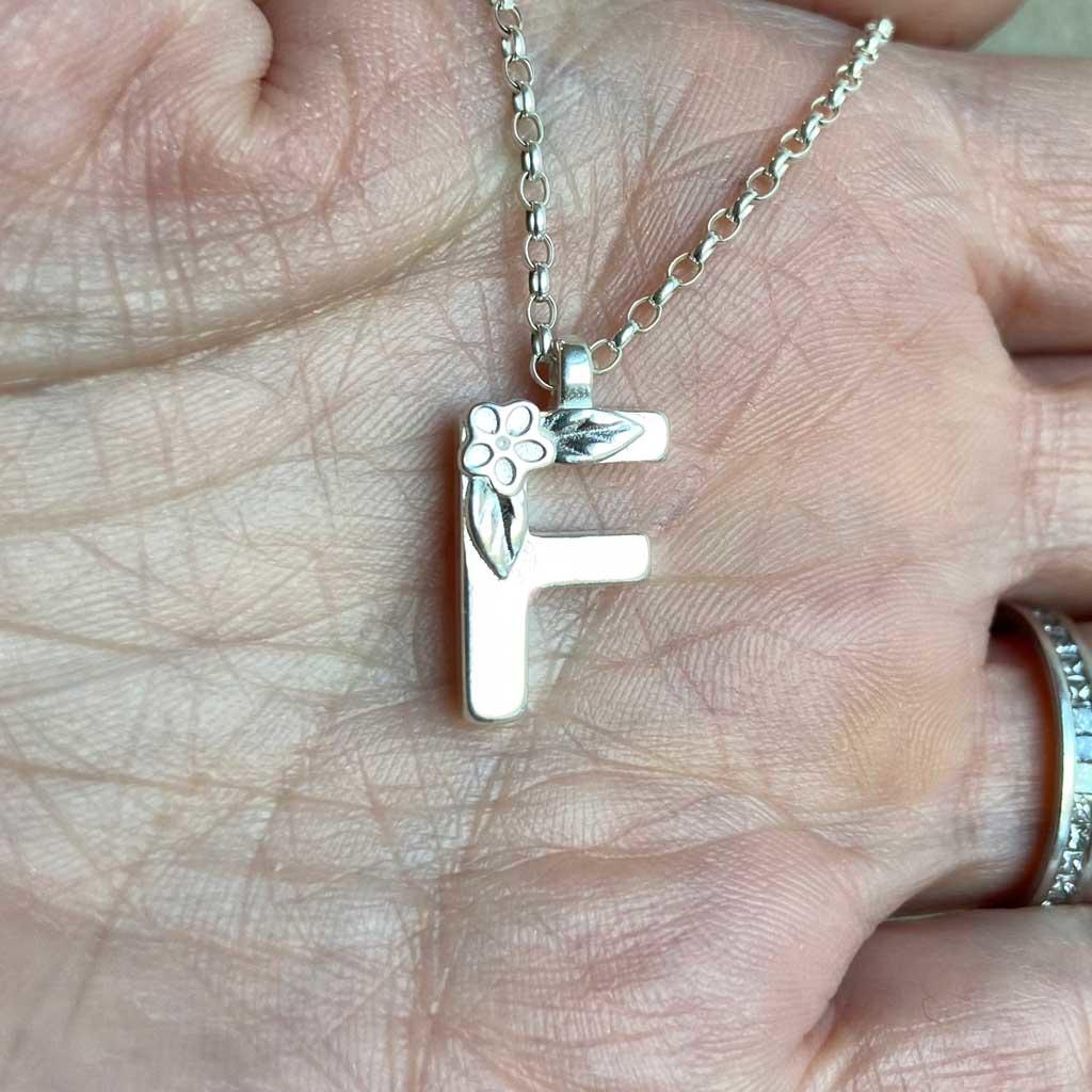 Silver Letter Necklace made by Elin Mair, image property of THE JEWELLERY MAKERS. in hand-2