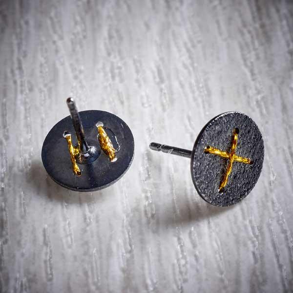 Oxidised Silver Stud Earrings with Gold Cross by Sara Bukumunhe. Image property of THE JEWELLERY MAKERS.-1
