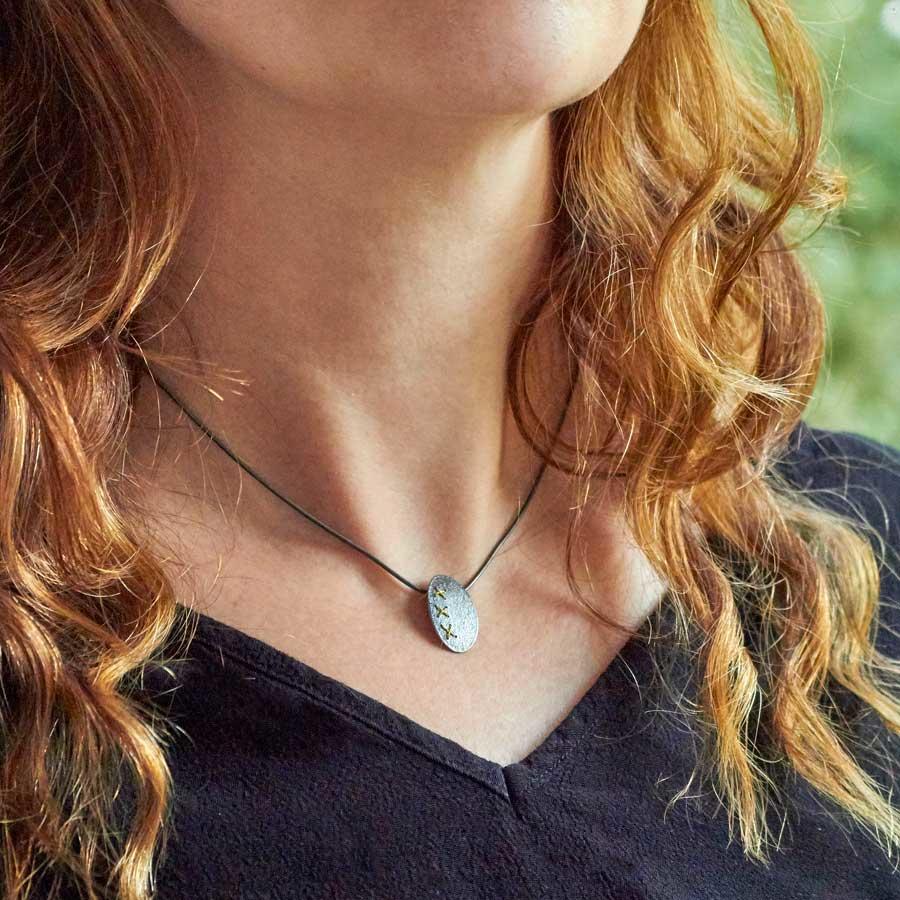 Oxidised (Black) Silver Oval cross-stitch Necklace with Gold thread by Sara Bukumunhe-1
