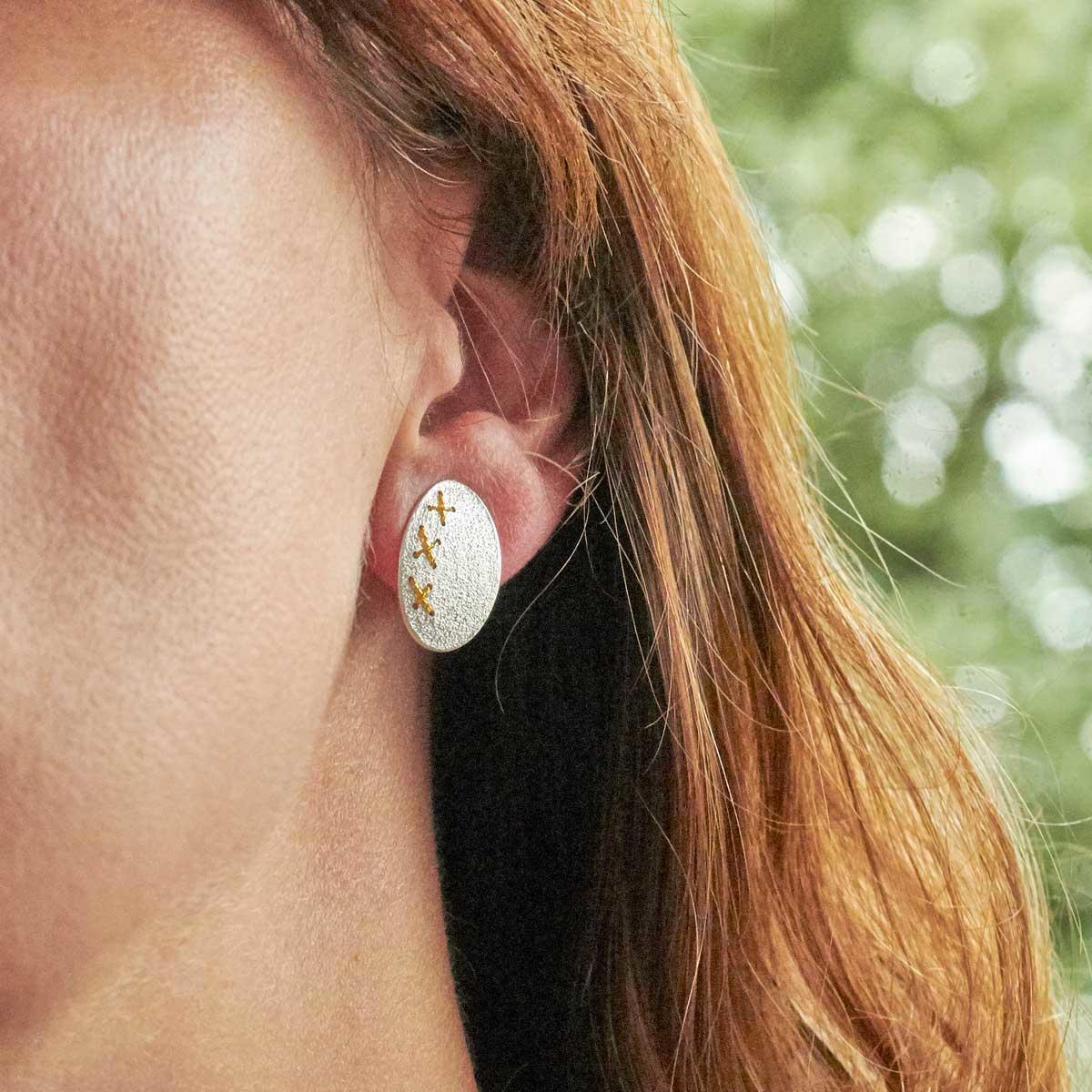 Large silver Cross-Stitched Studs by Sara Bukumunhe. Image property of THE JEWELLERY MAKER.-1