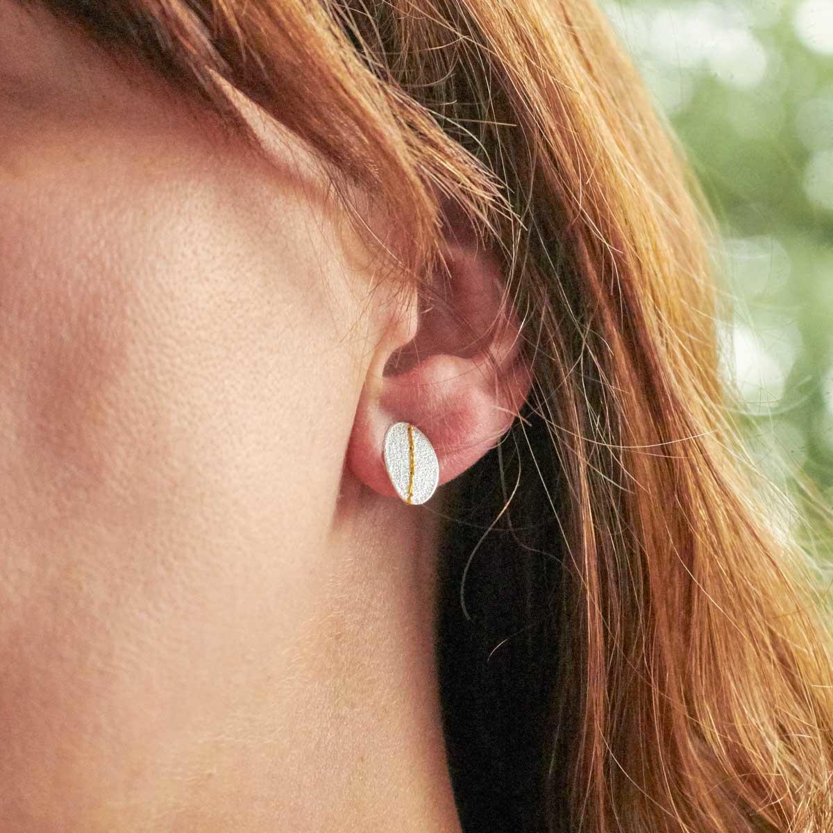Silver sewn up textured stud earring with gold thread by Sara Buk. Image property of THE JEWELLERY MAKERS.-2