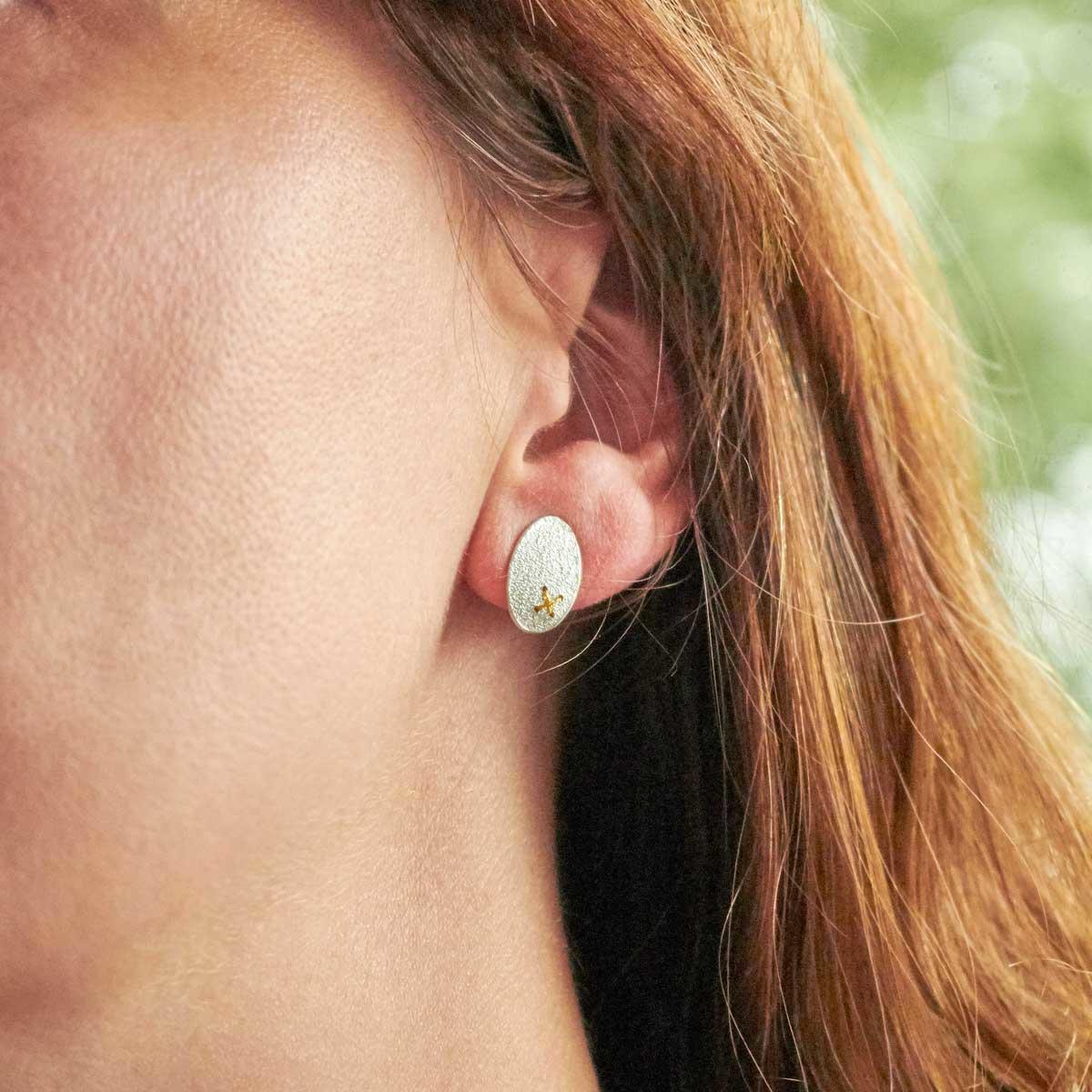 Silver Oval Studs with Tiny Gold Thread Cross Stitch by Sara Bukumunhe. Image property of THE JEWELLERY MAKERS-2