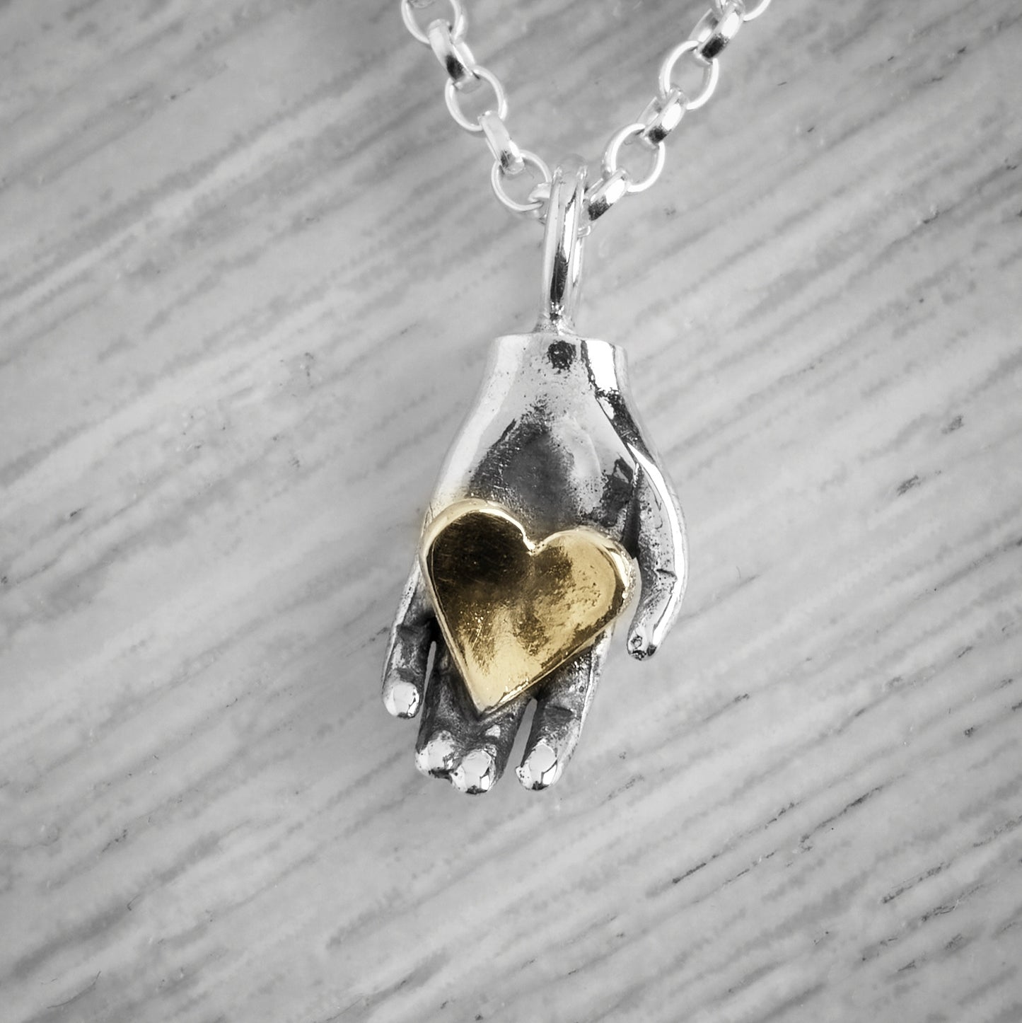 Tiny Heart in Hand Necklace by Emma White