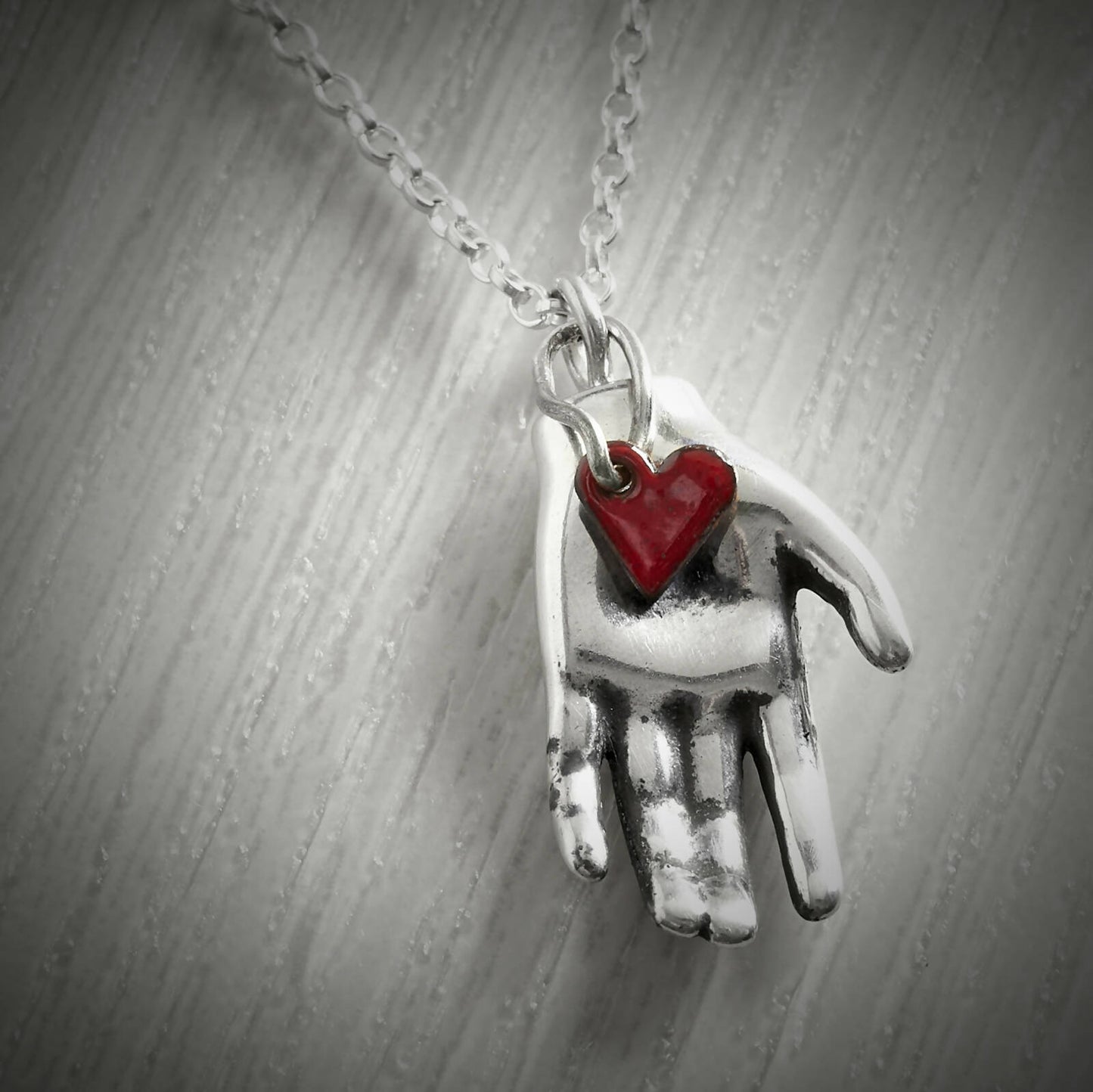 Red Heart in Hand Necklace by Emma White