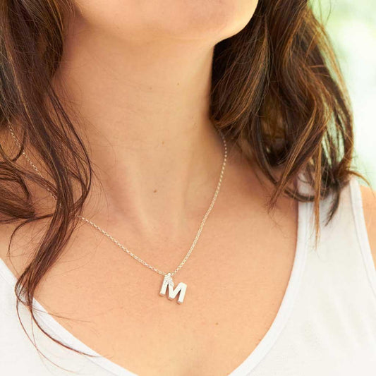 Silver letter M made by Elin air, Image property of THE JEWELLERY MAKERS worn on.-1