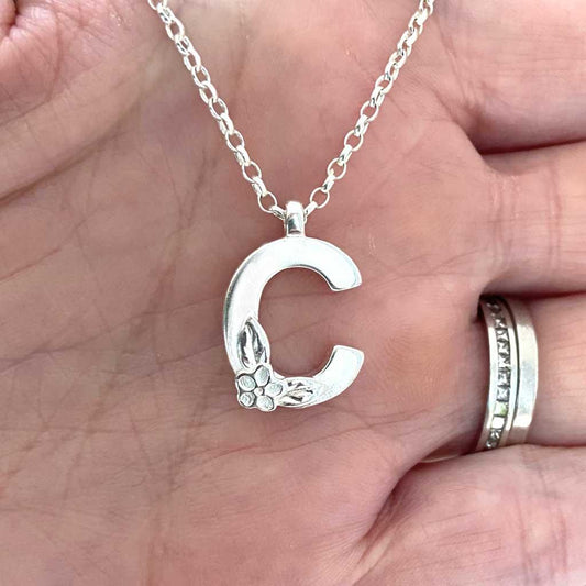 Silver initial necklace - Letter C - by Elin Mair. Image property of THE JEWELLERY MAKERS in hand-1