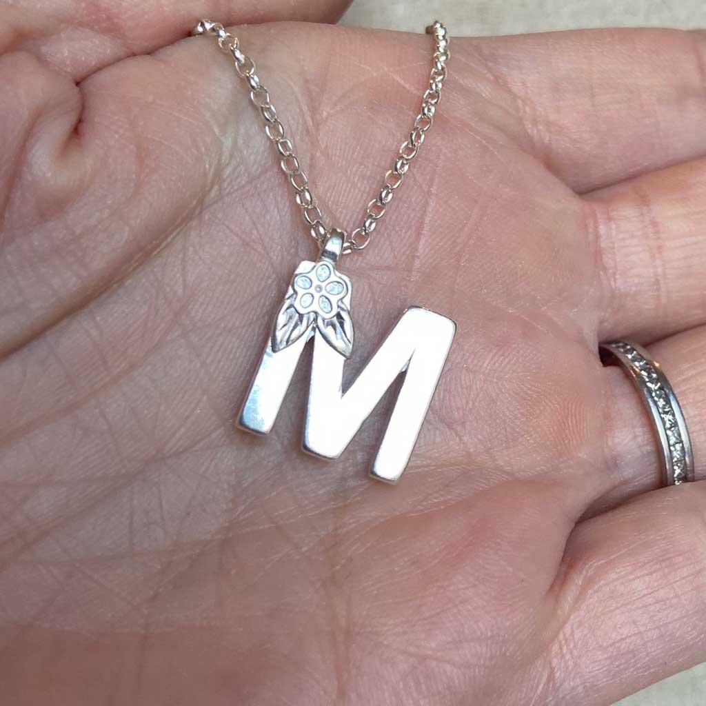 Silver letter M made by Elin air, Image property of THE JEWELLERY MAKERS in hand-2