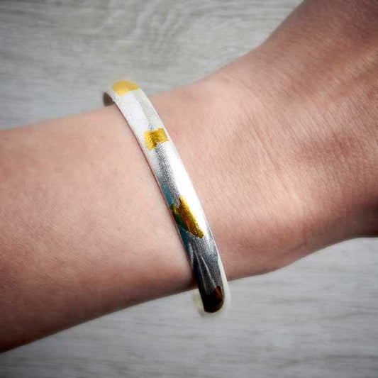 Handmade silver and gold Keum Boo bangle by Fi Mehra, worn on an arm-0