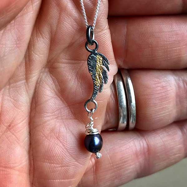 Angel Wing Oxidised Pendant by Fi Mehra, silver and gold keum boo with a fresh water dark pearl in the hand-0