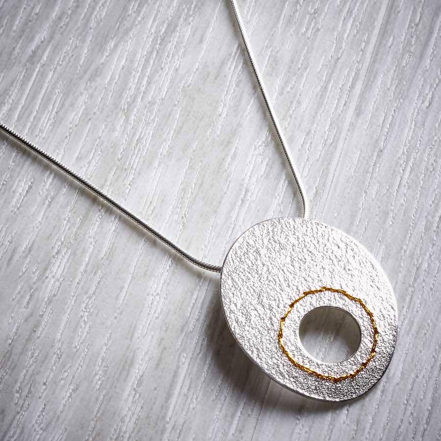 Silver Cut-out Circle Necklace sewn with Gold thread by Sara Bukumunhe-1