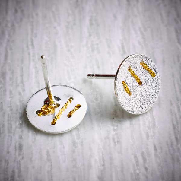 Silver Studs with 3 Gold Thread Stitches by Sara Bukumunhe. Image property of THE JEWELLERY MAKERS.-1