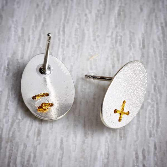 Silver Oval Studs with Tiny Gold Thread Cross Stitch by Sara Bukumunhe. Image property of THE JEWELLERY MAKERS-1