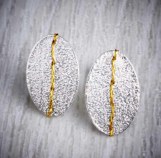Silver sewn up textured stud earring with gold thread by Sara Buk. Image property of THE JEWELLERY MAKERS.-0